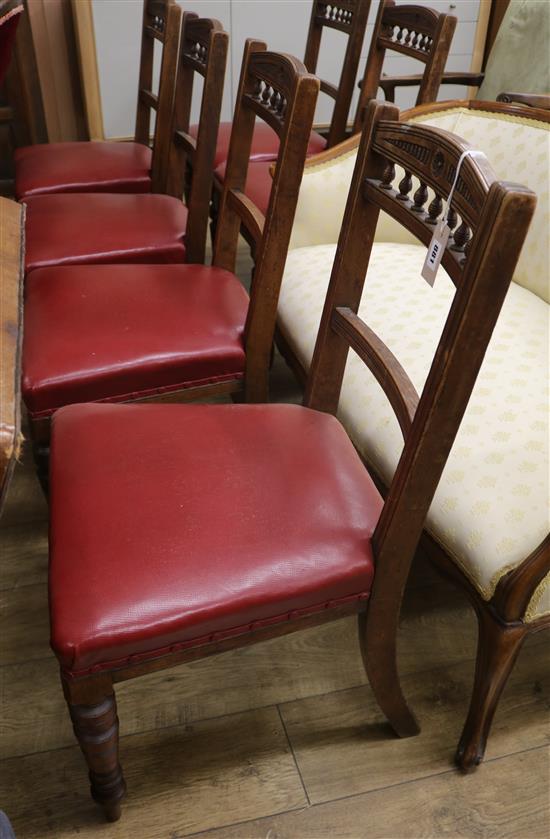 A set of six late Victorian walnut dining chairs with red hide-covered seats